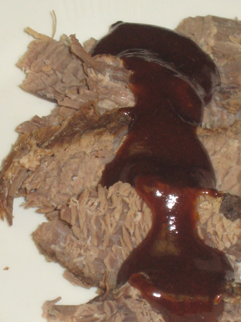 Sliced beef brisket and sauce