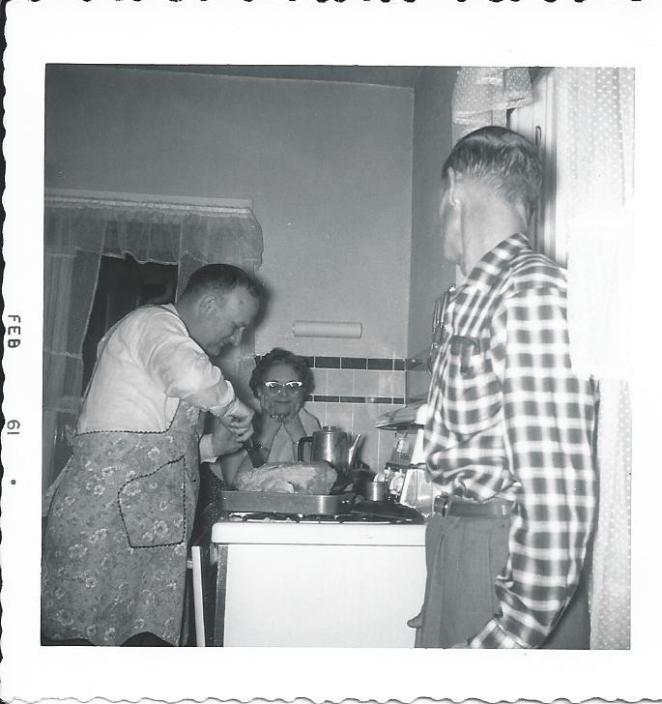 Uncle George carves Christmas turkey while Aunt Wilma and Archie watch 1961